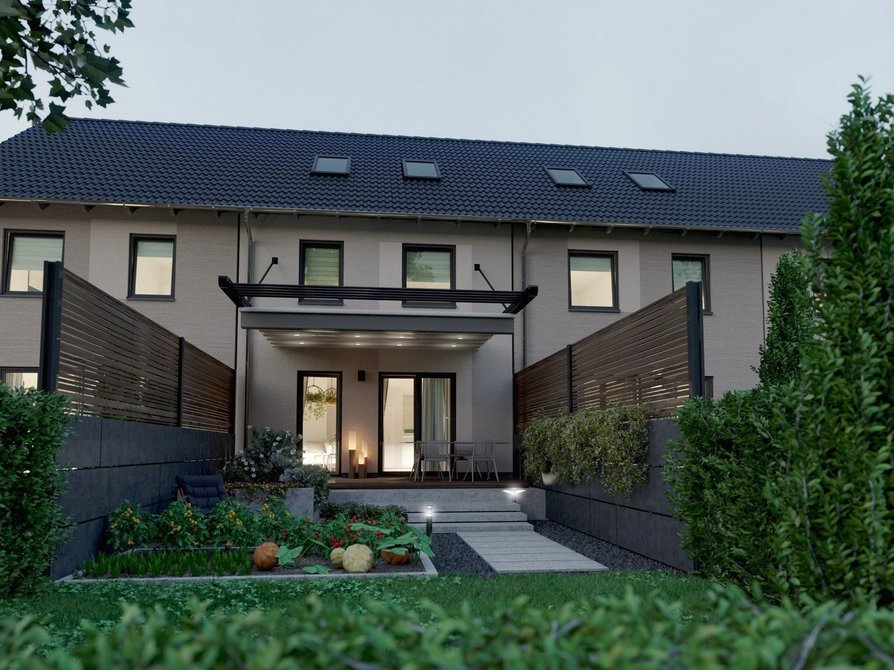 Massiv gebautes Reihenhaus Mainz 128 mit vier Wohneinheiten Gartenansicht in Abendstimmung